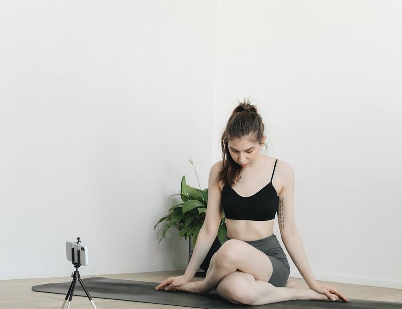 Clean minimalist yoga space with mat and plants